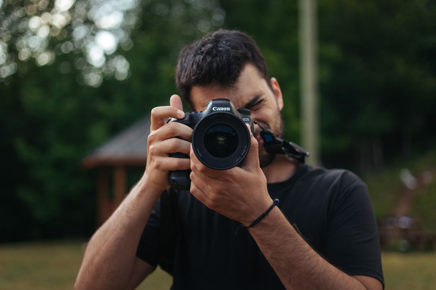 Omer shooting with a Canon camera at camp